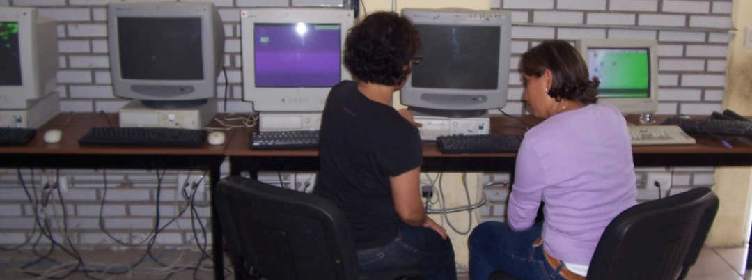 Kids on Computers volunteers and students at work in new KoC computer lab